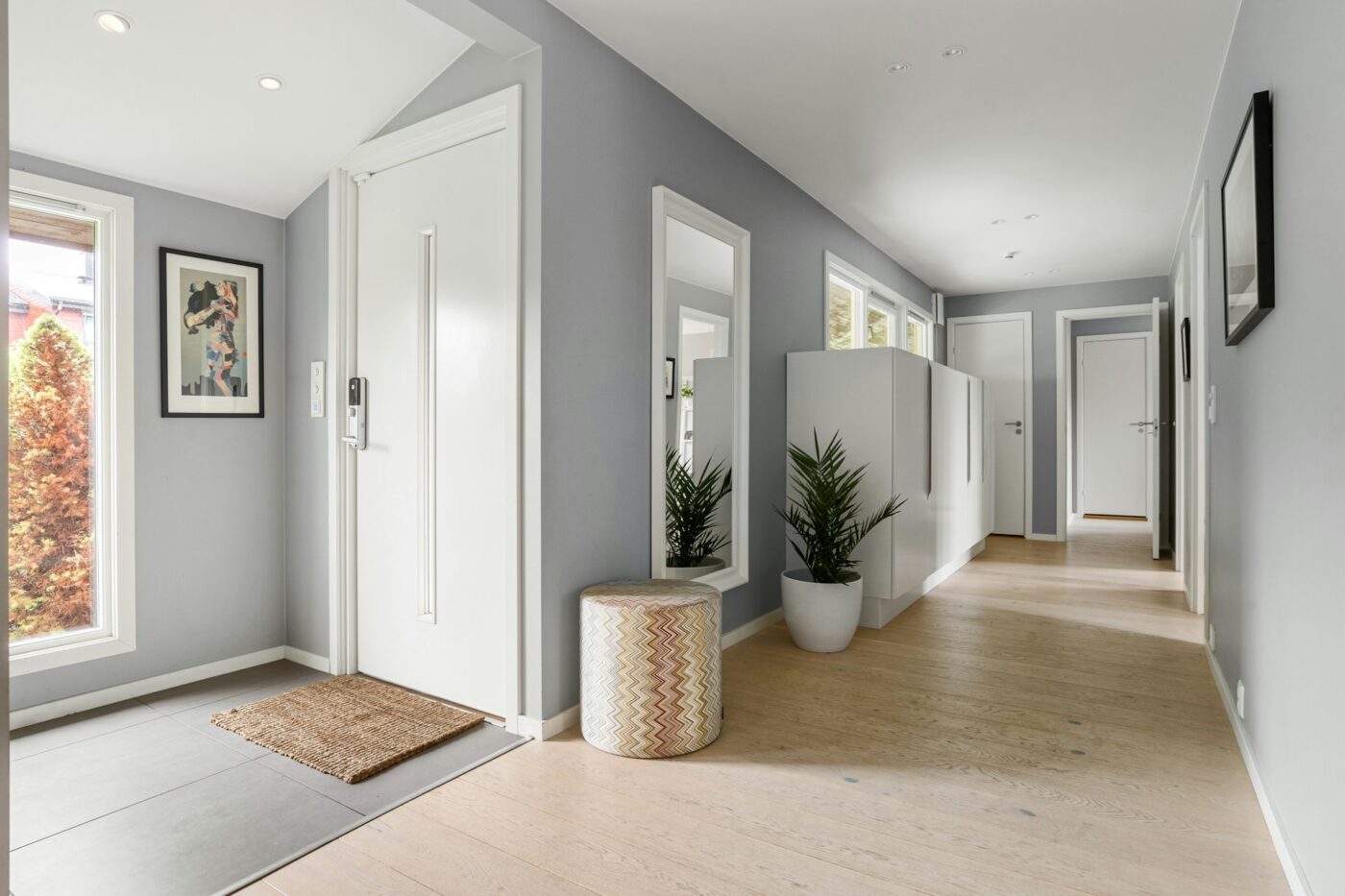 Modern hallway with freshly painted gray interior walls and white trim